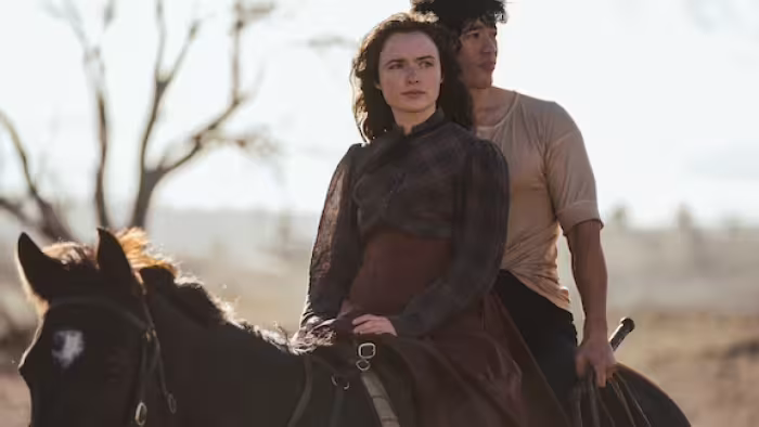 My Brilliant Career TV show screenshot: A young woman and man ride a horse in the Australian countryside