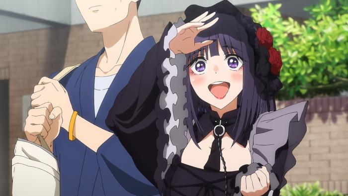My Dress-Up Darling: Kitagawa, in a maid outfit with a chain collar, looks happily into the distance. Gojo stands next to her, his face out of screen.