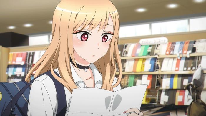 My Dress-Up Darling: Kitagawa studies a paper list of supplies while shopping for cosplay crafting materials.
