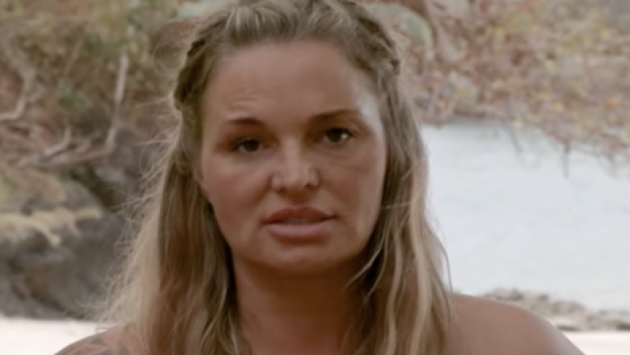 Naked and Afraid Castaways screenshot 2: Blond haired heather faces forward while articulating her survival skills. 