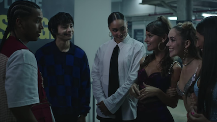 Neon screenshot 3: A group of girls stand across Santi in front of Felix and Ness. 