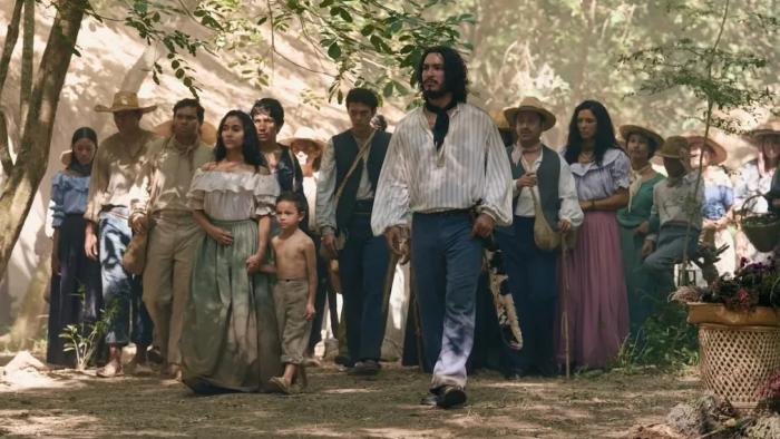 One Hundred Years of Solitude TV show screenshot 2: José Arcadio Buendía leads a group of villagers through the trees