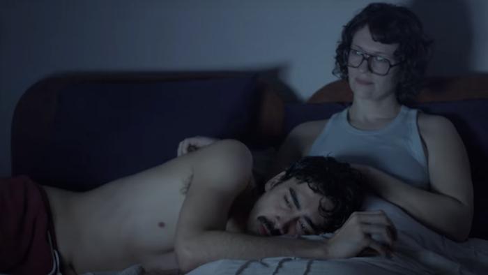 People Like Me TV Show screenshot 1: Devon Vongirdner and Ava Gordy lay in bed. Vongirdner has his head in Gordy’s lap as she pats his head.