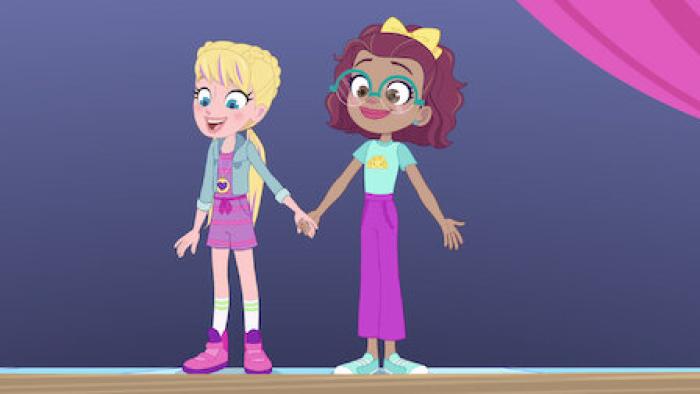 Polly Pocket Sparkle Cove Adventure: An animated White girl and Black girl stand next to each other holding hands and looking surprised.