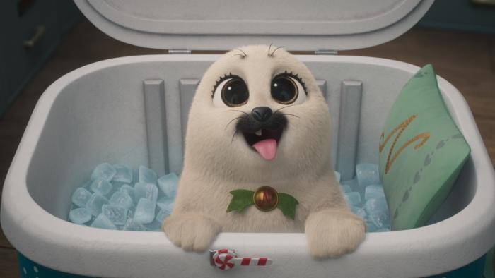 Prep & Landing The Snowball Protocol TV show screenshot 3: Eggnog, a white baby otter, peaks out of an igloo container filled with ice and a pillow.