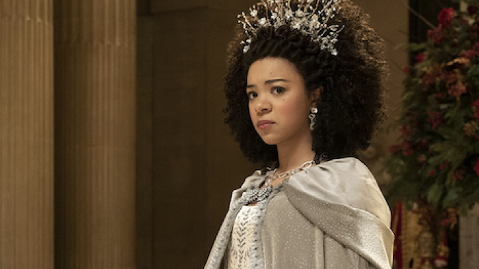 Queen Charlotte screenshot 1: Queen Charlotte in wedding dress and headpiece looks upset after King George leaves. 