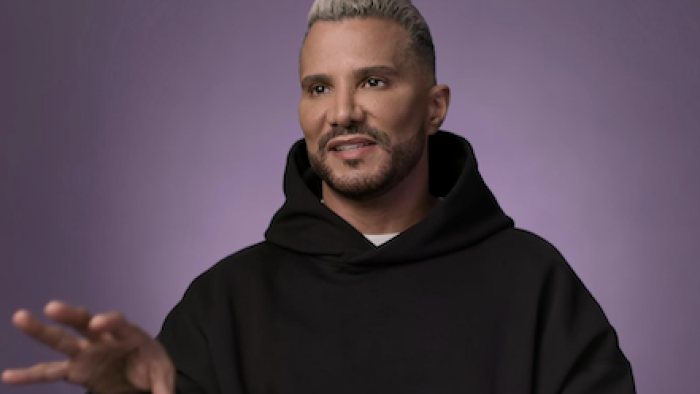 Reality Check: Inside ANTM TV show screenshot 2: Jay Manuel wearing a black sweater against purple backdrop. 