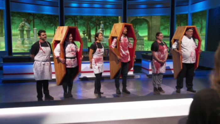 Recipe for Disaster TV show screenshot 3: contestants spattered with blood and wearing coffins