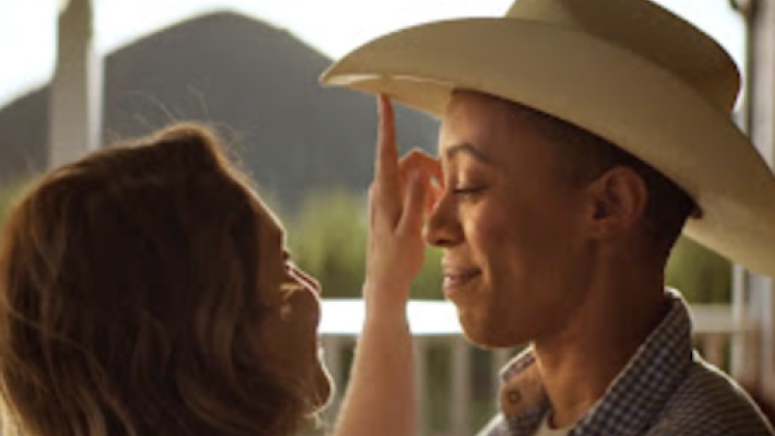Reframed: Next Gen Narratives TV show screenshot 1: Andia Winslow with cowboy hat being pushed up.