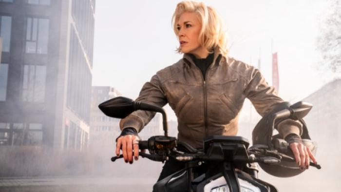 Ride or Die: assassin Judith (Hannah Waddingham) on a scooter