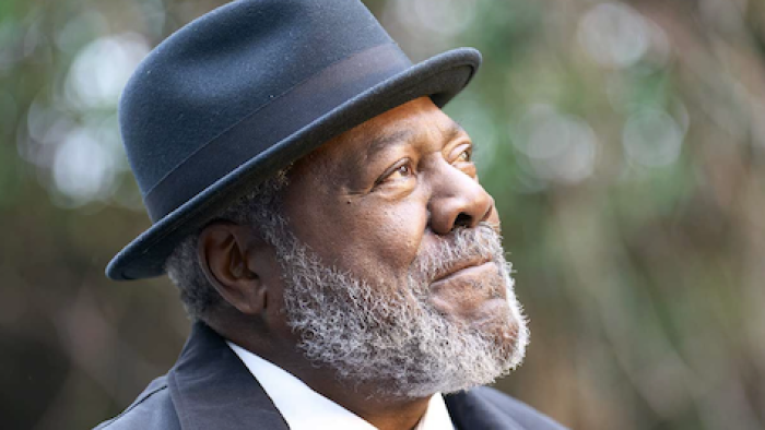 Ripple TV show screenshot 3: Walter wears a black hat and looks up at the sky.
