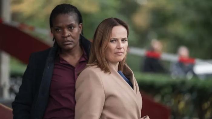 Nemesis TV show screenshot: A White woman and a Black woman stand side by side with background blurred.
