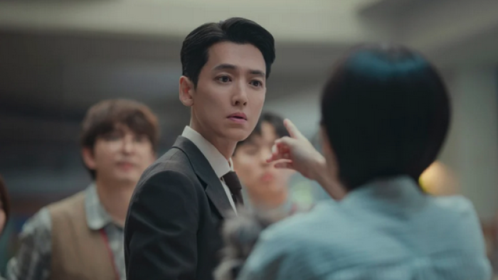 Pro Bono TV show screenshot: An East Asian man in a suit is getting pointed at by a short-haired woman in the foreground