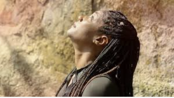 Tiffany Haddish Goes Off TV show screenshot: Close up of Tiffany Haddish looking up in front of some mountains.