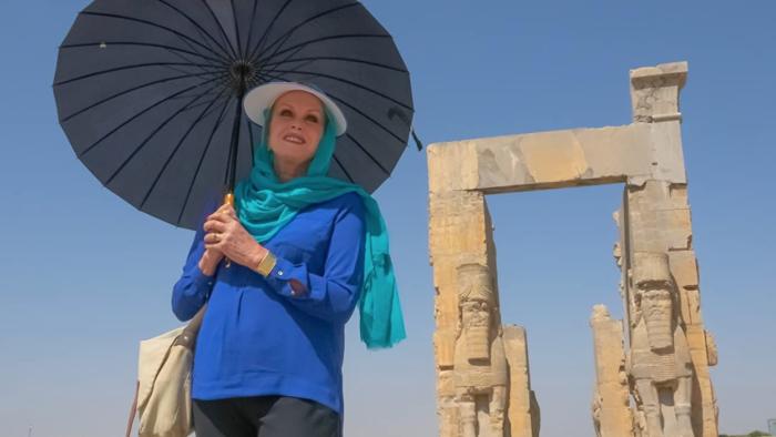 Joanna Lumley's Silk Road Adventure: Joanna Lumley stands holding a parasol, with ancient ruins behind her.