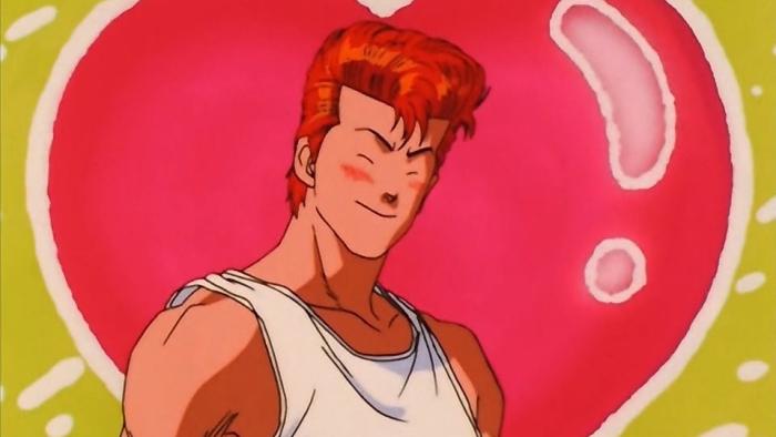 Slam Dunk TV show screenshot 2: Hanamichi smiles cheerfully. Behind him is a large pink heart against a yellow background.
