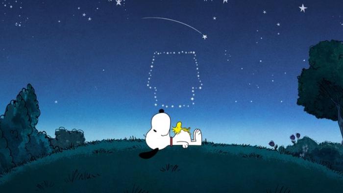 Snoopy Presents There's No Place Like Home Snoopy TV: Snoopy lays on the grass with Woodstock on his belly watching a doghouse shaped constellation.