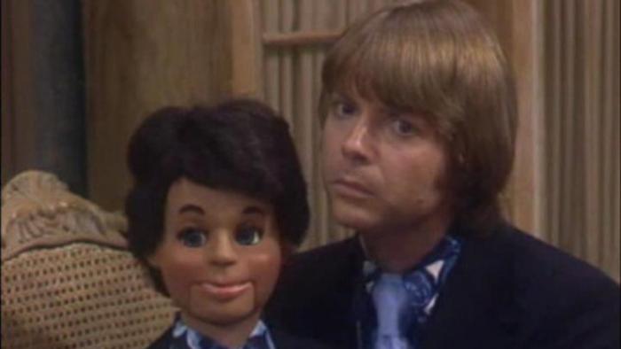 Soap: Chuck holds his dummy Bob on his lap and looks at something off-camera with a discomfited expression