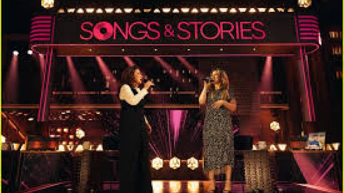 Songs and Stories with Kelly Clarkson TV show screenshot #3: Clarkson and a woman sing together