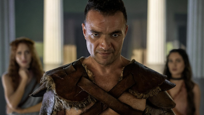 Spartacus: House of Ashur screenshot 1: Ashur stares forward with Hilara and Messia behind him. 
