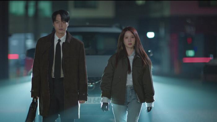 Spooky in Love TV show screenshot: A Korean man and woman walk at night on a foggy street