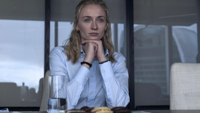 Steal TV show screenshot 1: Zara Dunne stares out a window in front of plate of cookies. 