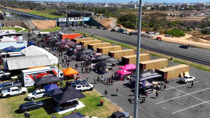 Street Outlaws vs. The World TV show screenshot 3: An aerial view of the track in Australia show containers and cars.