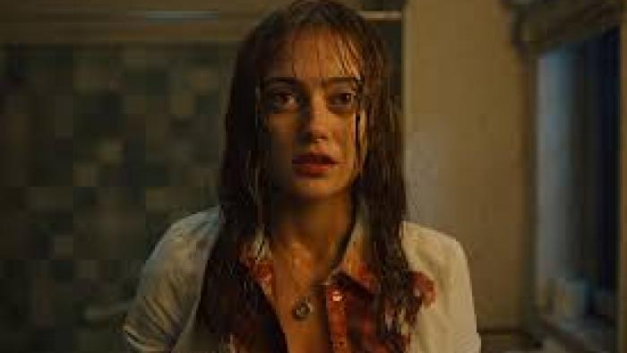Sweetpea TV show screenshot #1:  A young White woman wears a bloodied top and looks into the camera