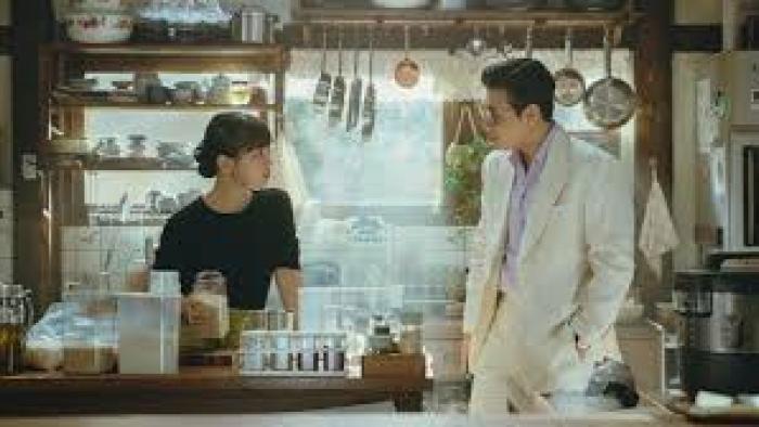 Tastefully Yours TV show screenshot #1: A young Korean man and woman chat in a food shop