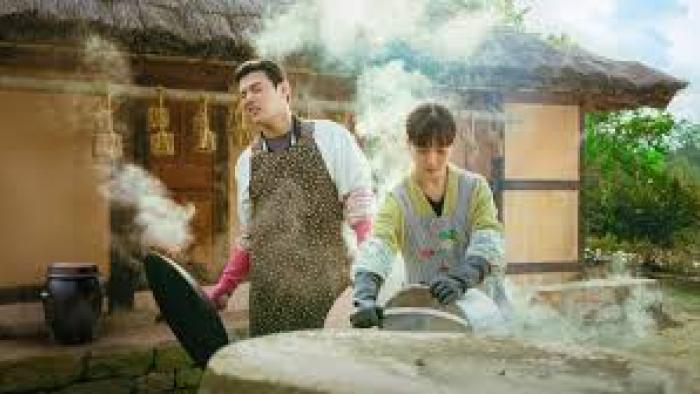 Tastefully Yours TV show screenshot #2: A young Korean man and woman stand over an outdoor grill