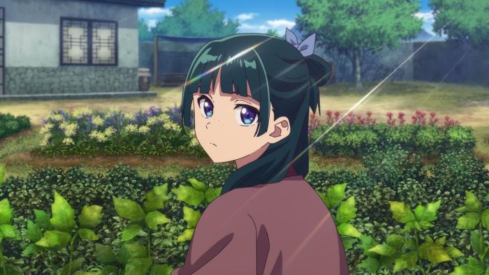 The Apothecary Diaries TV show screenshot 1: Maomao, crouched in a field of herbs, looks over her shoulder.