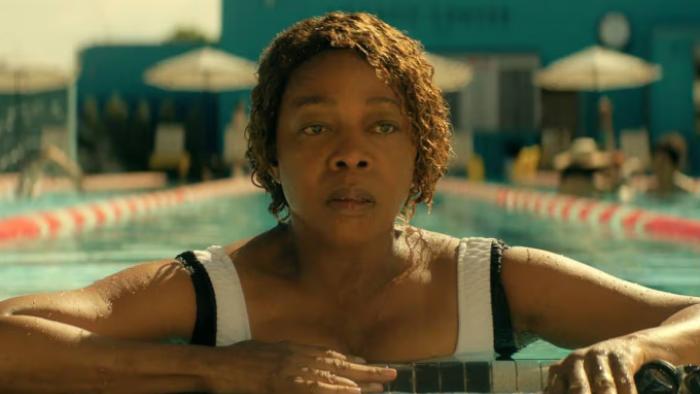 The Boroughs TV show screenshot 3: Judy stares into the distance as she rests at the end of a swimming lane, appearing weary and saddened