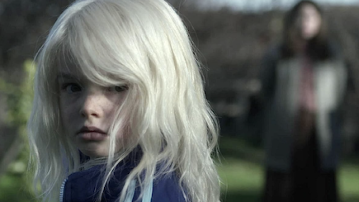 The Clearing TV show screenshot-2: Asha with died hair looks back. 