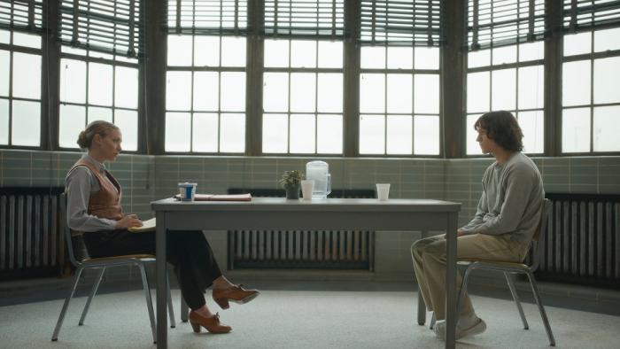 The Crowded Room: Amanda Seyfried and Tom Holland sit across from each other in a room. 