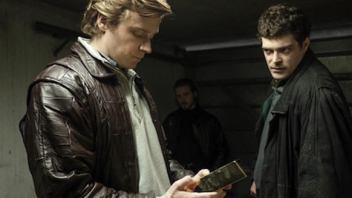 The Gold TV show screenshot 2: Kenny Noye (Jack Lowden) examines a brick of buillion while Brian Robinson (Frankie Wilson) watches.