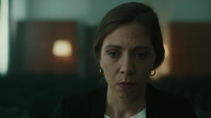 Barbara Chichiarelli sits in a dark room.