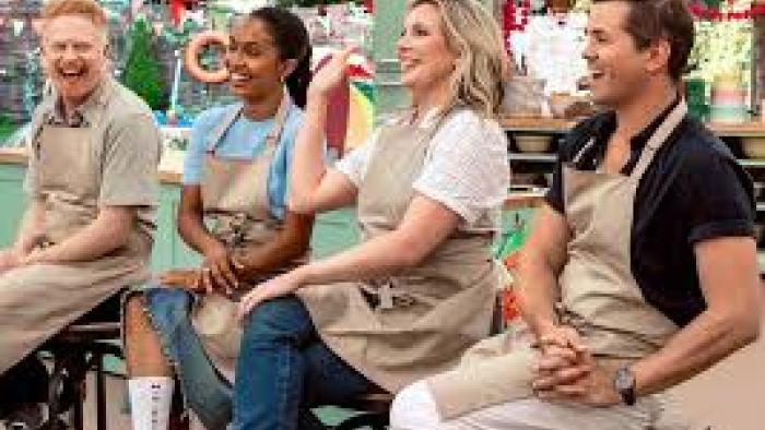 The Great American Baking Show: Celebrity Summer TV show screenshot #1: celebrity contestants sit on stools, wearing aprons