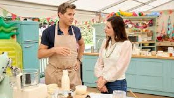 The Great American Baking Show: Celebrity Summer TV show screenshot #3: a celebrity contestant talks to the host