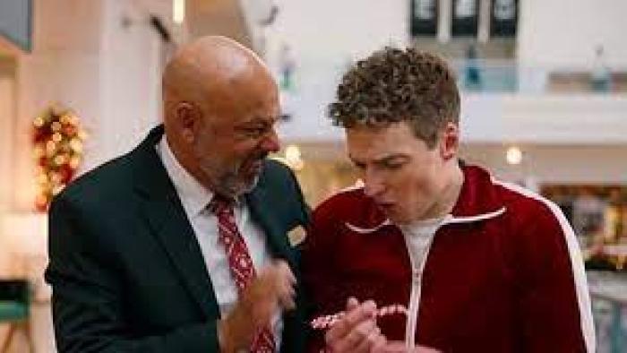 The Holiday Shift TV show Screenshot #3: a middle-aged and younger man stand together looking at a candy cane