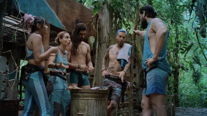 A group of men and women talking in the jungle