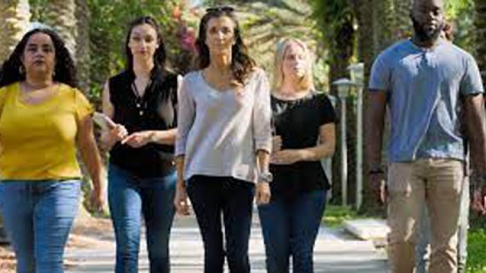 The Lesson is Murder: Dr. Fox and her team of graduate students are shown walking side by side down a street.