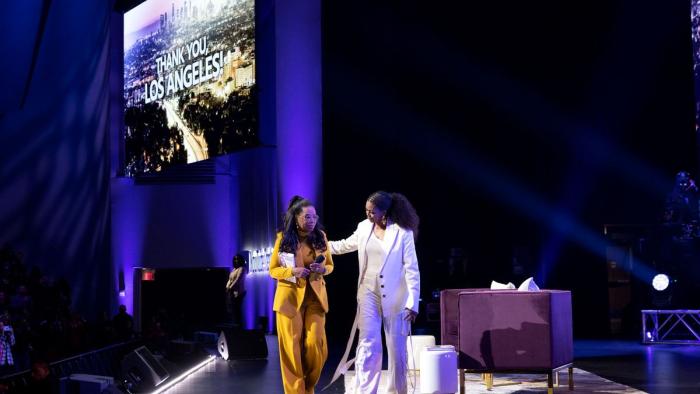 The Light We Carry: Michelle Obama and Oprah Winfrey walk out on stage with a photo of Los Angeles in the background
