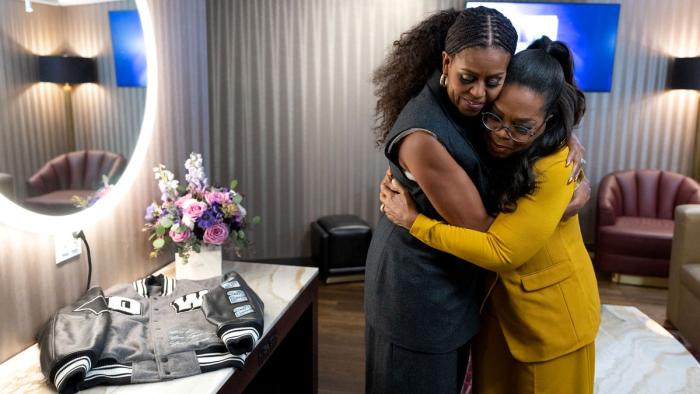 The Light We Carry: Michelle Obama and Oprah Winfrey hug in a dressing room