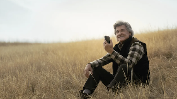 The Madison TV show screenshot 2: Preston Clyburn in plaid shirt sitting on grassy hillside