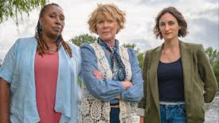 The Marlow Murder Club TV show screenshot 1: three middle-aged women stand together, looking seriously at the camera