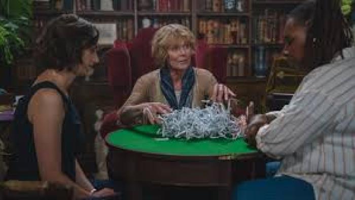 The Marlow Murder Club TV show screenshot #3: three middle-aged women sit around a small, round table