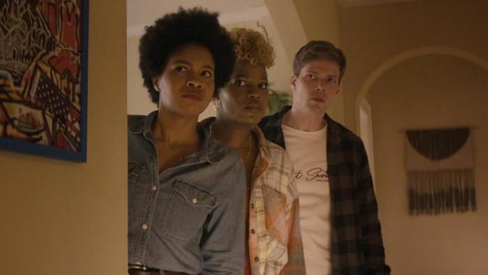 The Other Black Girl TV show screenshot 1: Sinclair Daniel, Brittany Adebumola and Hunter Parrish are concerned as they look around a corner. 