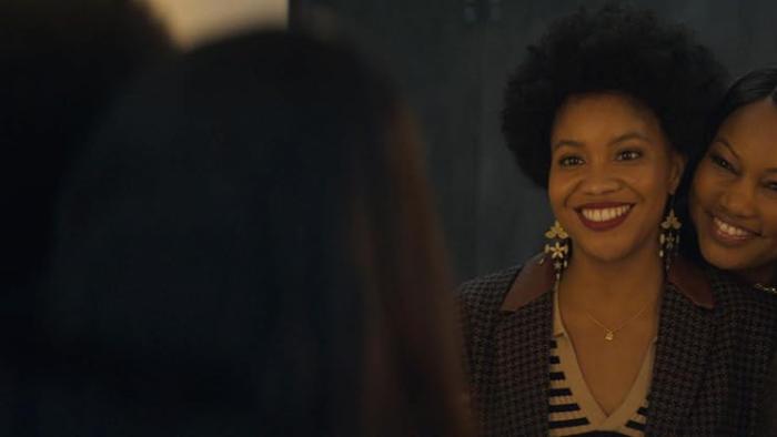 The Other Black Girl TV show screenshot 2: Garcelle Beauvais leans on Sinclair Daniel, smiling at her. 
