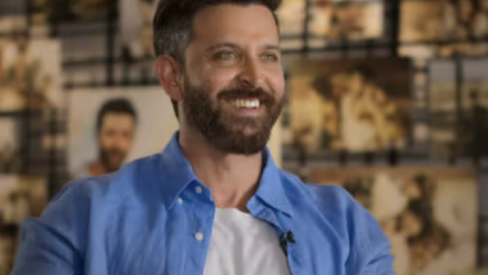 The Roshans TV show screenshot 1: Hrithik Roshan wears open blue shirt over white t-shirt. 