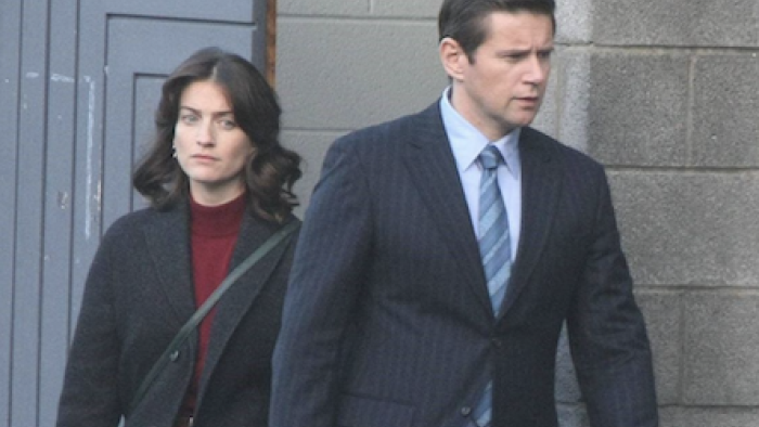 The Vanishing Triangle screenshot 2: Lisa Wallace and Detective Burke leave gray cement building. 